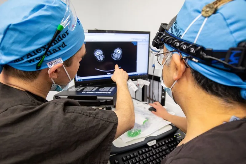 Clinicians reviewing implant imaging during surgical planning